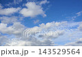 Textured clouds are flying across the blue sky. Timelapse. 143529564