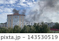 Black smoke rising over burning city 143530519