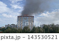 Black smoke rising over burning city 143530521