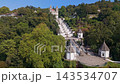 This aerial shot captures the Bom Jesus do Monte sanctuary in Braga, Portugal. View the church and its famous staircase surrounded by trees and landscape features. Orbit parallax shot 143534707