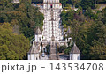 Aerial shots of Bom Jesus do Monte in Braga, Portugal. This church and shrine feature a notable staircase. The views highlight its architecture and surrounding nature. Pedestal tilt shot 143534708