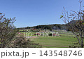 A peaceful landscape of rural mountains and farming villages viewed through the trees. 143548746