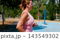 Woman Jogging Outdoors in a Park on a Sunny Day 143549302