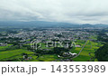Aerial footage of rice paddies and residential areas in Kobayashi City, Miyazaki Prefecture. 143553989