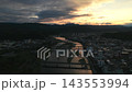 Aerial footage of the town area along the Kuma River in Hitoyoshi City, Kumamoto Prefecture, at sunset. 143553994