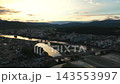 Aerial footage of the river and city of Hitoyoshi, Kumamoto Prefecture at sunset. 143553997