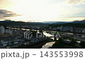 Aerial footage of the Kuma River and city center in Hitoyoshi City, Kumamoto Prefecture, at sunset. 143553998