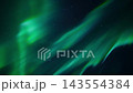 Flowing green aurora borealis curtains sweeping across dark starry night sky, long diagonal bands of teal and emerald light showing gentle undulating motion, ethereal celestial atmosphere captured in 143554384