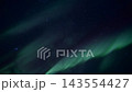Aurora borealis sweeping green ribbons across starry northern night sky in wide angled view capturing celestial glow and soft cloud layers under tranquil darkness 143554427