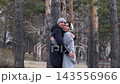 Loving couple embracing in a pine forest during a cold weather walk 143556966