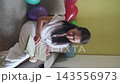 Thoughtful woman holding a carnation and writing notes. Mindfulness, memories and calm inner dialogue. 143556973