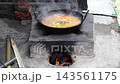 Traditional South Asian Fish Curry Cooking in Metal Pan Kadai over Clay Stove Chulha - Rural Village Kitchen Concept Traditional South Asian Fish Curry Cooking in Metal Pan Kadai over Clay Stove Chulha - Rural Village Kitchen Concept 143561175
