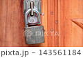Unlocked Metal Padlock Hanging on Wooden Door Latch - Tala, Home Security, Access, and Safety Concept Unlocked Metal Padlock Hanging on Wooden Door Latch - Tala, Home Security, Access, and Safety Concept 143561184