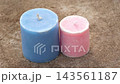 Two Unlit Pillar Candles in Blue and Pink Colors on Wooden Surface - Mombatti, Home Decor, Relaxation, and Spa Concept Two Unlit Pillar Candles in Blue and Pink Colors on Wooden Surface - Mombatti, Home Decor, Relaxation, and Spa Concept 143561187