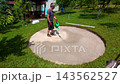 Preparing the ground for pool construction in a backyard during summer with leveling and sand 143562527