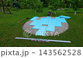 Pool foundation preparation and leveling process in backyard for summer project 143562528