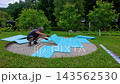 Preparing the backyard for a pool installation by leveling the ground and using foam panels 143562530