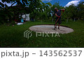 Preparing the ground for a pool installation in the backyard with sand and leveling tools 143562537