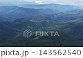 Explore Carpathians in Ukraine with aerial views of mountains and valleys surrounded by forests and meadows 143562540