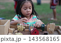 preschool child girl playing with wooden toy block at the outdoor 143568165