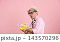 Playful senior man having fun with a water gun 143570296
