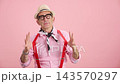 Eccentric senior man with positive energy posing on a pink background 143570297