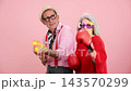 Playful senior couple having fun with toys 143570299