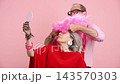 Stylish senior couple having fun with pink wig 143570303