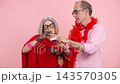 Eccentric senior couple taking pills and supplements for healthy longevity 143570305