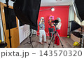 Cheerful senior friends filming a funny video in a home studio 143570320