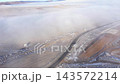 Aerial view of misty countryside road, hoarfrost in in a cold winter morning by drone 143572214