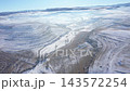 Aerial view of misty countryside hills at wintertime, morning fog above by drone 143572254