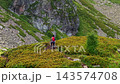Aerial View of Female Hiker Walking on Mountain Trail 143574708