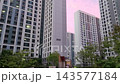 Tilt Up View of Pink Sunset Sky and High Rise Apartment Buildings at Dusk 143577184