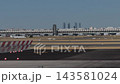White Airplane Taxiing at Madrid-Barajas Airport Under Clear Sky 143581024
