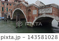 Historic Stone Arch Bridge Over Quiet Venetian Canal 143581028