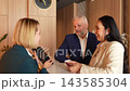 Business interaction with an Asian woman at a stylish reception area 143585304