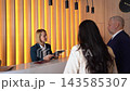 Welcoming guests at a chic reception desk in a modern hotel 143585307