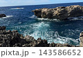 Fungus Rock at Dwejra Bay on Gozo island in Malta rises from the blue Mediterranean sea as waves break along limestone cliffs. Rocky coastline, natural landmark, island travel, coastal scenery of Gozo 143586652