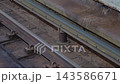 A rat runs beside the train tracks inside a dirty subway or metro station environment. Underground transportation infrastructure, urban wildlife, and gritty public transit conditions create a 143586671