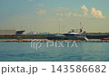 A modern luxury yacht rests near the Chicago harbor during a warm summer evening. Calm lake water and soft clouds create an elegant waterfront atmosphere. 143586682