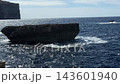 Fungus Rock at Dwejra Bay on Gozo island in Malta stands in the Mediterranean sea, with waves around its limestone base. Coastal landmark, rocky seascape, island sightseeing, natural scenery of Malta. 143601940