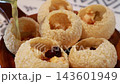 Pouring mint flavored water into traditional Indian panipuri golgappa snack. Pouring mint flavored water into traditional Indian panipuri golgappa snack. 143601949