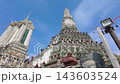 BANGKOK, THAILAND - 6th OCTOBER 2024: Camera tilts to Buddha statue from Thonburi Pagoda of Wat Arun in Bangkok Thailand on a sunny morning 143603524