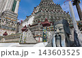 BANGKOK, THAILAND - 6th OCTOBER 2024: Camera tilts from Buddha statue to Thonburi Pagoda of Wat Arun in Bangkok Thailand on a sunny morning 143603525