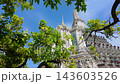 BANGKOK, THAILAND - 6th OCTOBER 2024: Camera slides from under tree to reveal Thonburi Pagoda of Wat Arun in Bangkok Thailand on a sunny morning  143603526