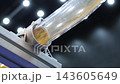 Plastic pneumatic conveying. Golden yellow plastic pellets flowing through transparent industrial tubing. Plastic manufacturing show material transport. Automated processing polymer production tech. 143605649