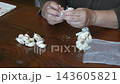 A woman dividing garlic 143605821