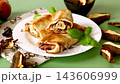 Savory crepes filled with porcini mushrooms on green background 143606999