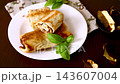 Homemade mushroom crepes with basil on dark wooden background 143607004